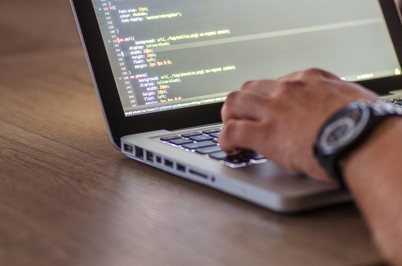 Developer writing code on a laptop for coding interview preparation