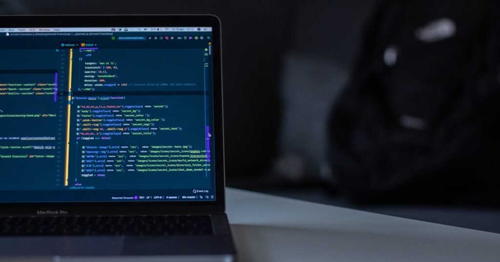 Engineer solving dynamic programming problem on a laptop during coding interview preparation