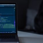 Engineer solving dynamic programming problem on a laptop during coding interview preparation