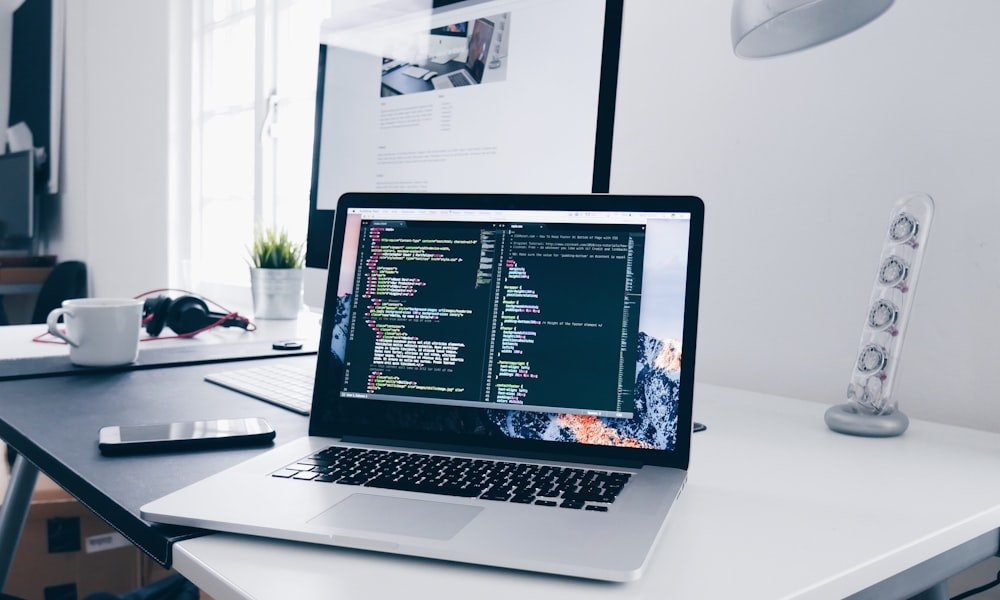 Developer working through code on a laptop