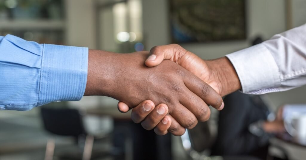 Candidate and interviewer shaking hands after a successful behavioral interview