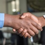 Candidate and interviewer shaking hands after a successful behavioral interview