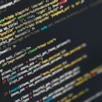 Code on a monitor representing dynamic programming practice