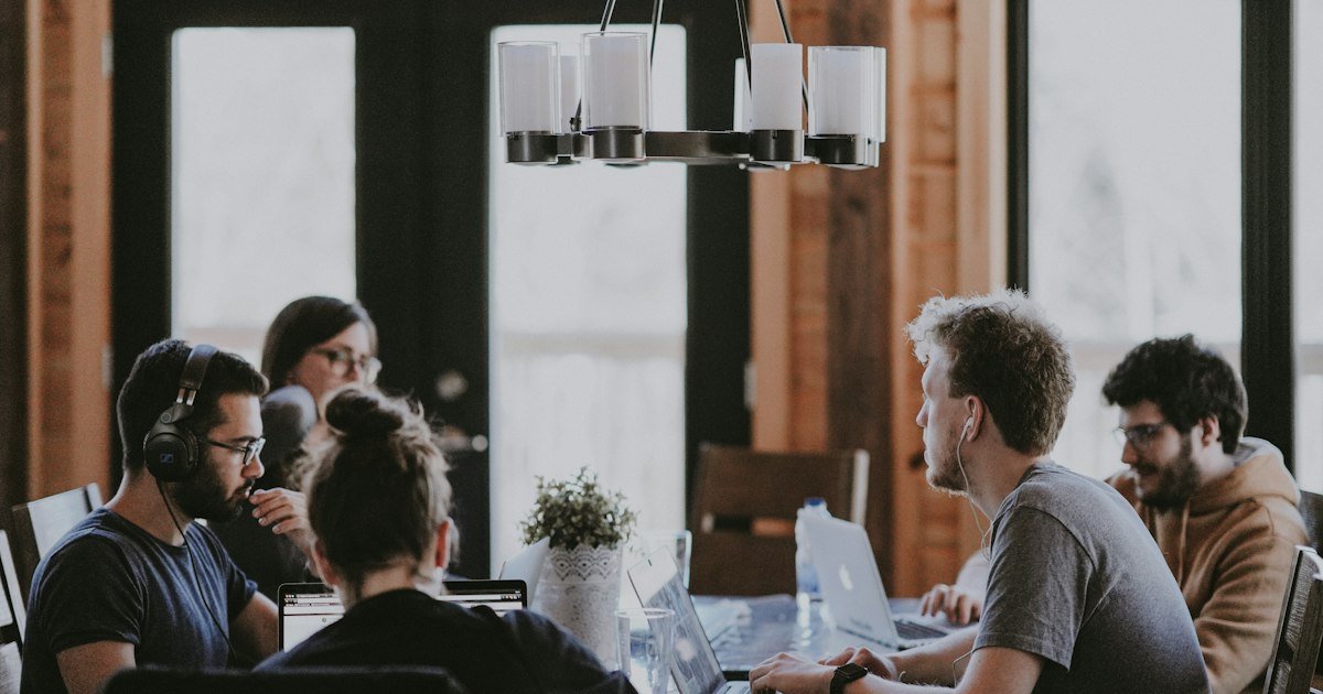 Team meeting around a table discussing compensation