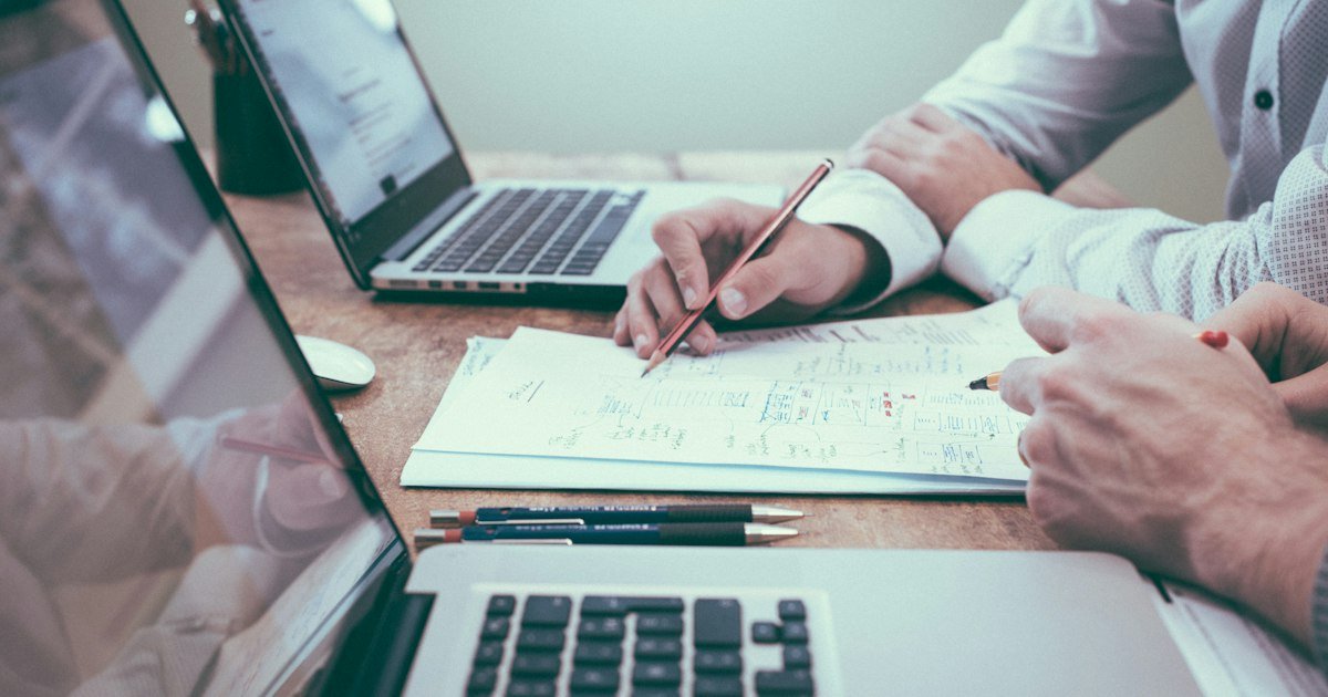 Documents and charts on a desk used to quantify resume impact