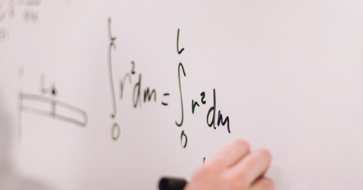 Engineer writing an algorithm on a whiteboard